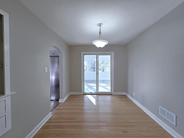 unfurnished dining area with light wood-type flooring