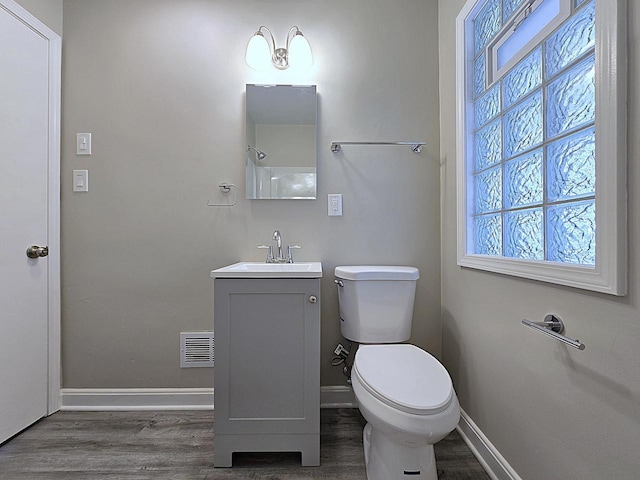 bathroom with vanity, hardwood / wood-style flooring, and toilet