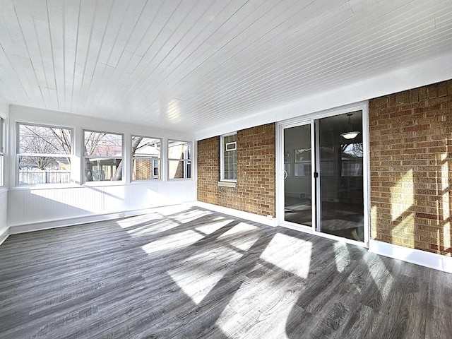 unfurnished sunroom with wood ceiling