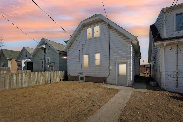 view of back house at dusk