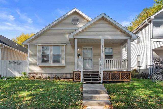 bungalow with a porch and a front lawn