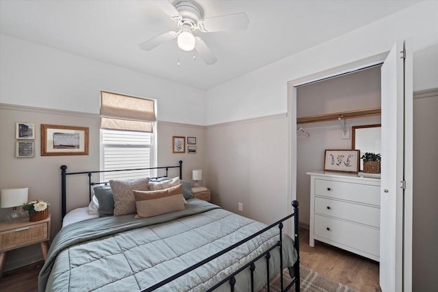 bedroom with hardwood / wood-style floors, a closet, and ceiling fan