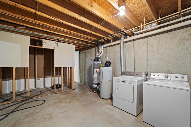 basement featuring washing machine and clothes dryer and water heater