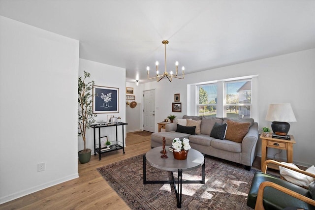 living room featuring a chandelier and light wood-type flooring