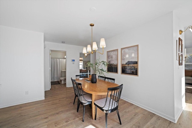 dining room featuring an inviting chandelier and light hardwood / wood-style floors