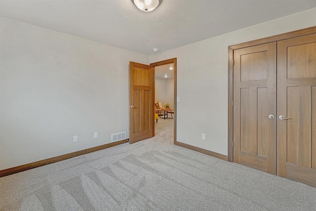 unfurnished bedroom featuring light carpet