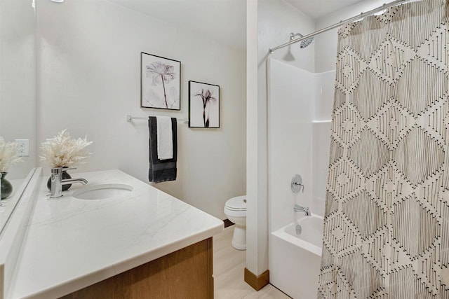 full bathroom with vanity, shower / bath combo, and toilet