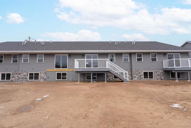 rear view of property with a wooden deck