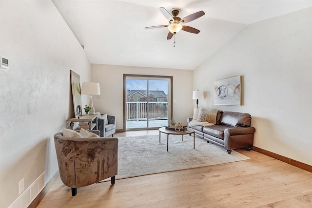 living room featuring ceiling fan, lofted ceiling, and light hardwood / wood-style floors