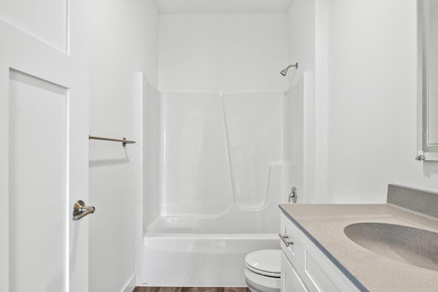 full bathroom featuring hardwood / wood-style flooring, vanity, toilet, and tub / shower combination