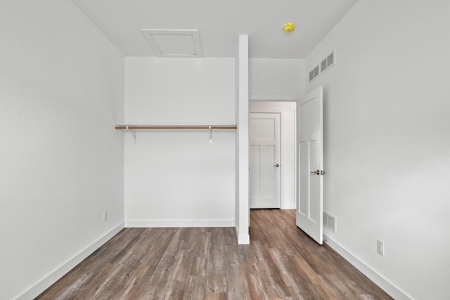 unfurnished bedroom featuring dark hardwood / wood-style floors and a closet