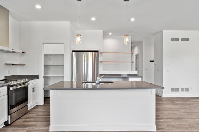 kitchen featuring appliances with stainless steel finishes, sink, and a kitchen island with sink