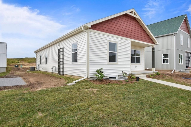 view of front facade with central AC and a front lawn