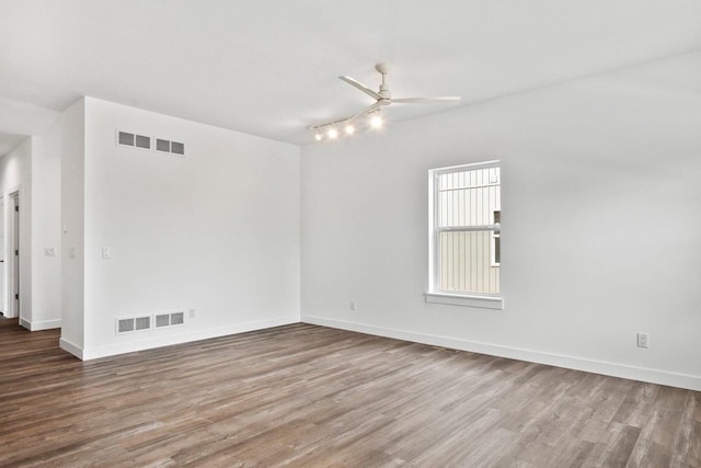 unfurnished room with hardwood / wood-style flooring and ceiling fan