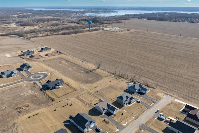 birds eye view of property featuring a water view and a rural view