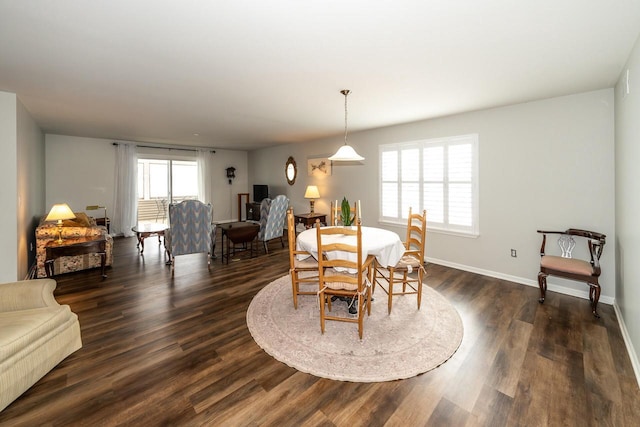 dining area with dark hardwood / wood-style flooring