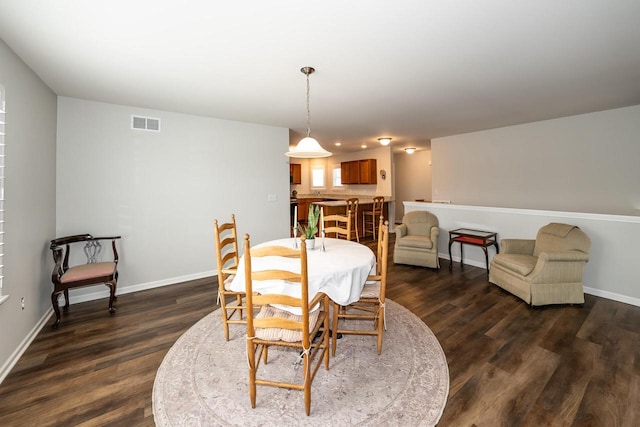 dining area with dark hardwood / wood-style flooring