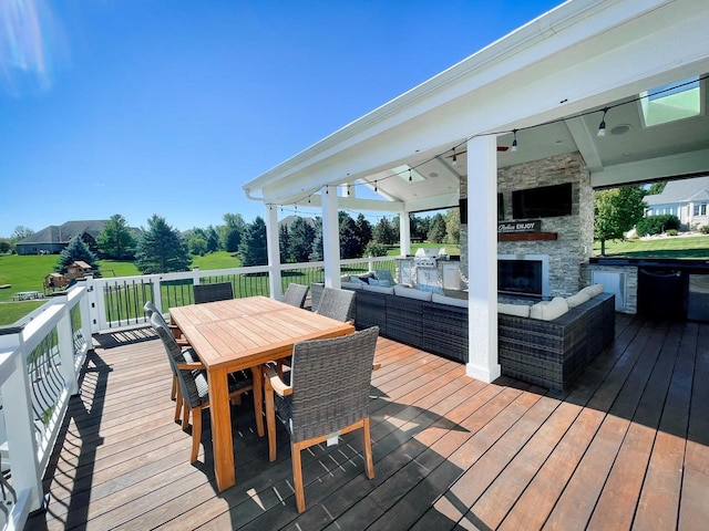 wooden deck featuring an outdoor living space with a fireplace