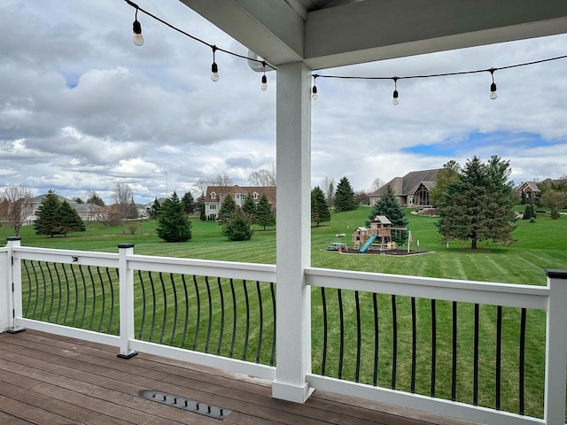 deck featuring a lawn and a playground