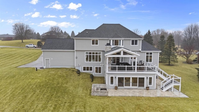 rear view of property with a patio and a lawn