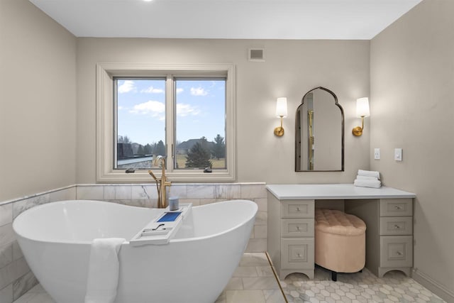 bathroom with a washtub and tile walls