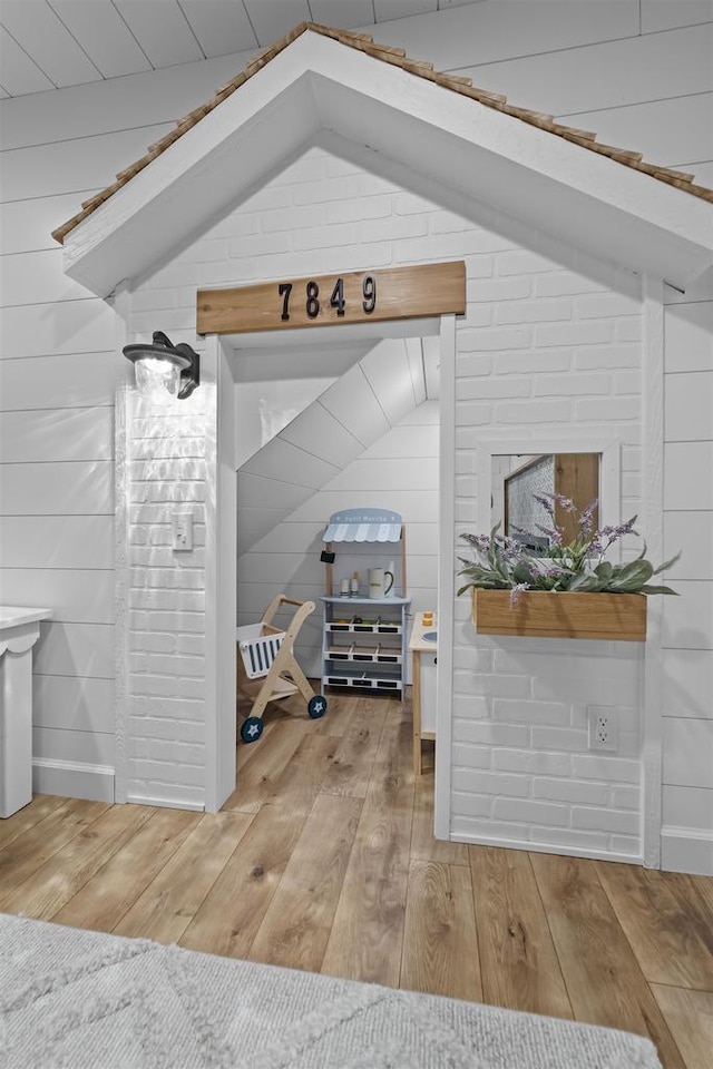 interior space with wood-type flooring and vaulted ceiling