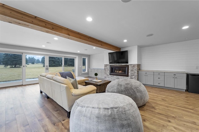 living room with beam ceiling and light hardwood / wood-style floors