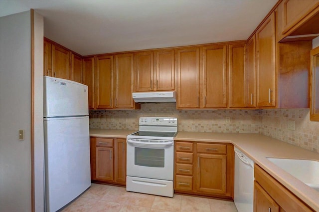 kitchen with tasteful backsplash, sink, and white appliances