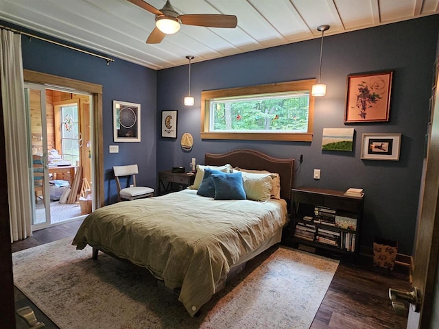 bedroom featuring dark wood-type flooring, ceiling fan, and access to outside