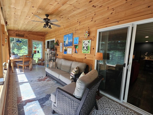 living room featuring ceiling fan, wooden ceiling, and wooden walls