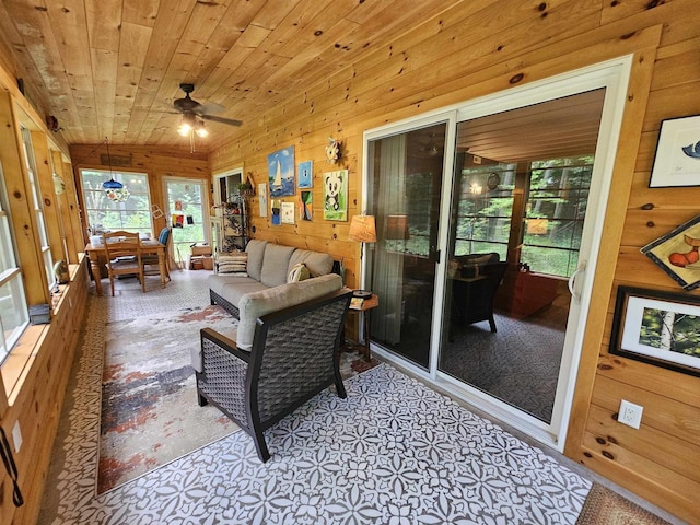 sunroom featuring ceiling fan and wood ceiling