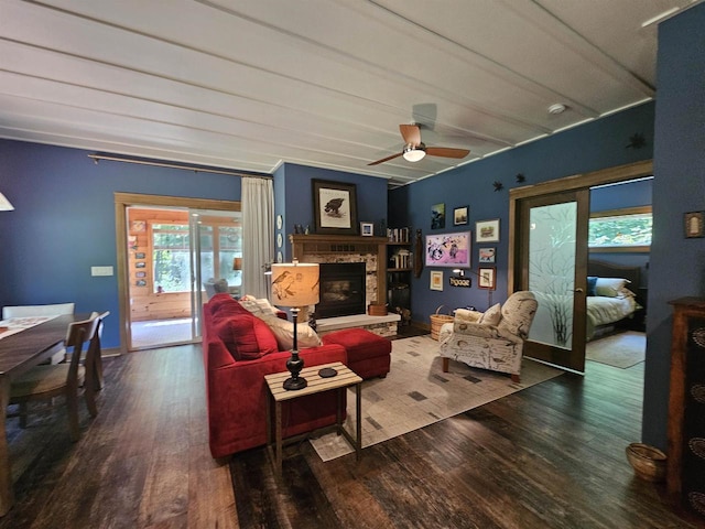 living room with lofted ceiling, hardwood / wood-style floors, a fireplace, and ceiling fan