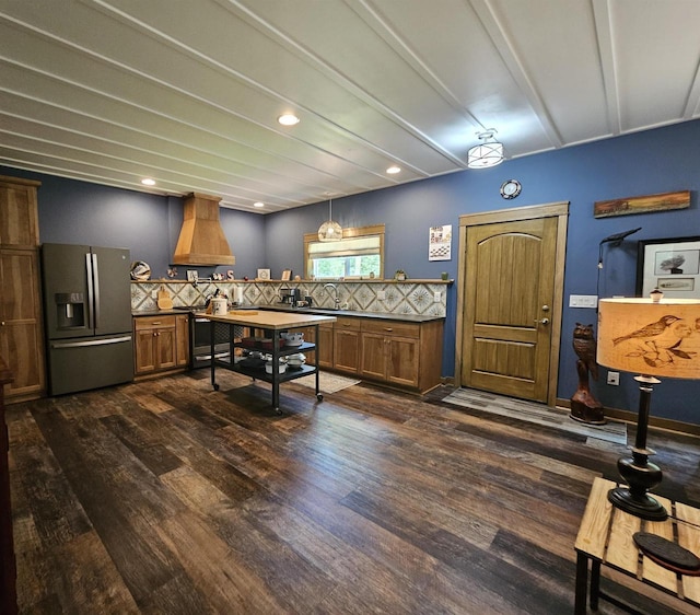 interior space featuring dark wood-type flooring, stainless steel fridge, tasteful backsplash, and beamed ceiling