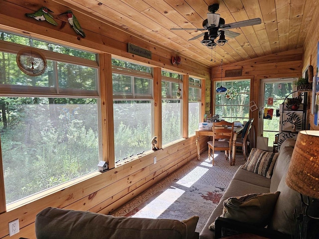 sunroom / solarium featuring ceiling fan, vaulted ceiling, wooden ceiling, and a healthy amount of sunlight