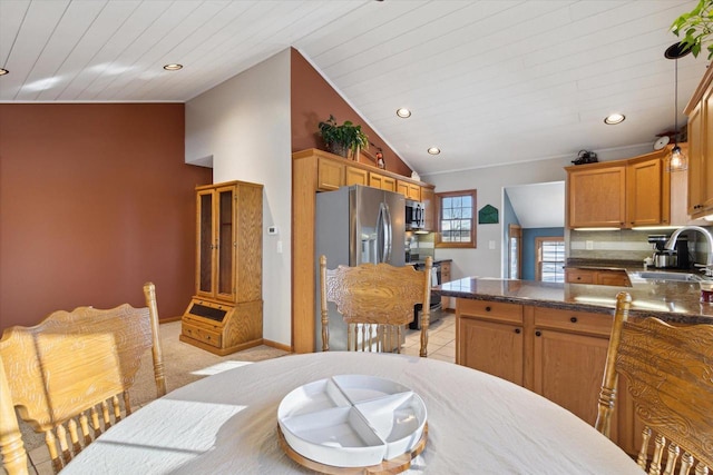 dining space featuring light colored carpet, lofted ceiling, sink, and wooden ceiling