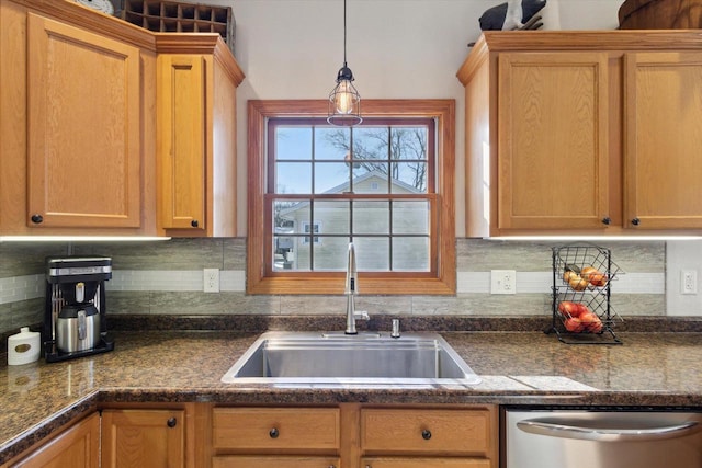 kitchen with decorative light fixtures, dishwasher, sink, and decorative backsplash