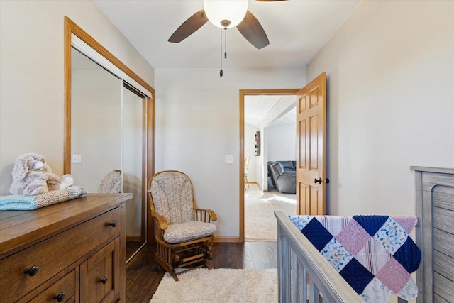 bedroom featuring dark wood-type flooring, ceiling fan, and a closet