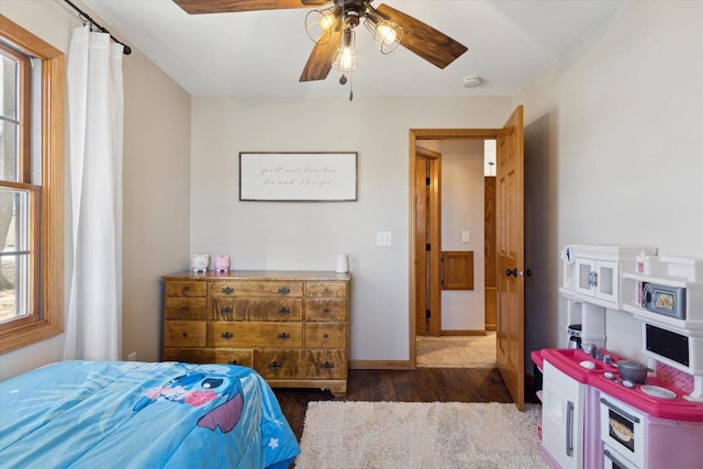 bedroom with dark wood-type flooring and ceiling fan