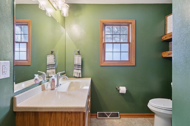 bathroom with vanity, tile patterned floors, toilet, and an inviting chandelier