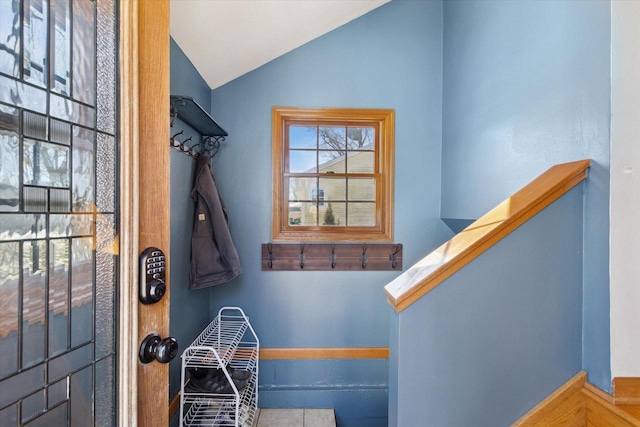 stairway featuring vaulted ceiling