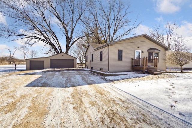 view of front facade featuring a garage and an outdoor structure