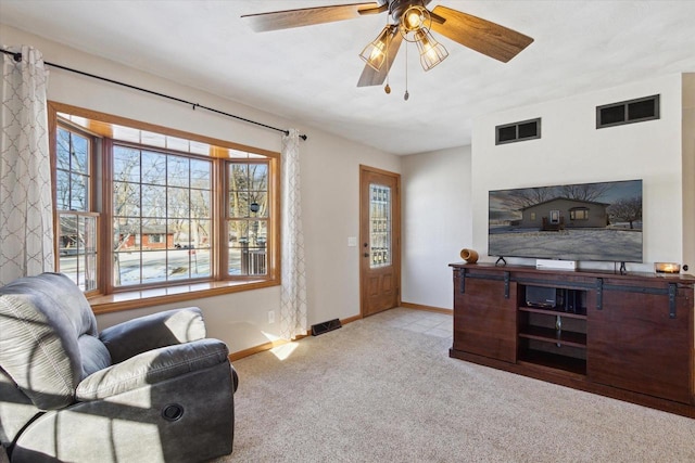 carpeted living room with ceiling fan