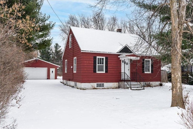 view of front facade featuring an outbuilding and a garage