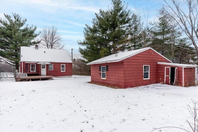 view of snow covered back of property