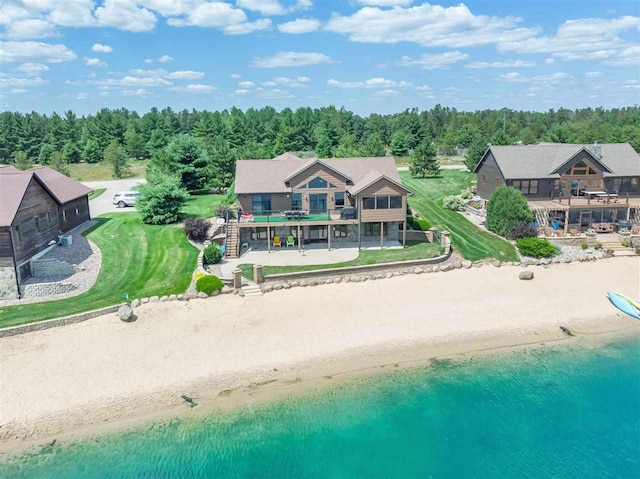 drone / aerial view with a water view and a beach view