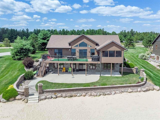 back of house featuring a yard, a deck, and a patio