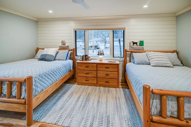 bedroom with ornamental molding and ceiling fan