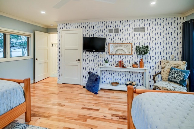 bedroom with crown molding and light hardwood / wood-style flooring