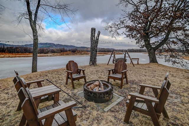 view of patio / terrace featuring a fire pit and a water view