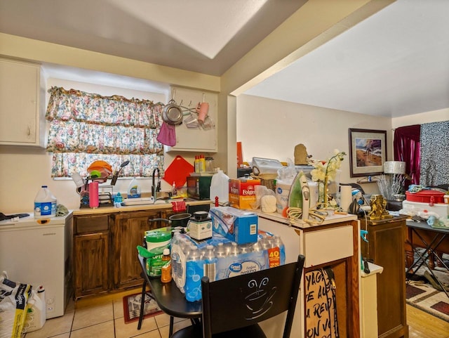 kitchen featuring sink and light tile patterned floors